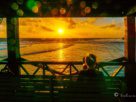 a woman is watching the sunrise in siargao