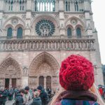 tourist taking a photo of notre dame cathedral in paris france