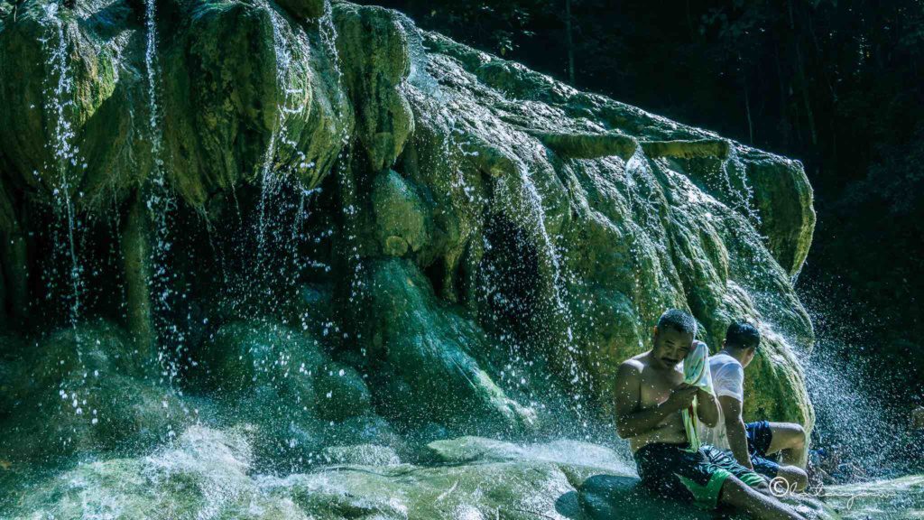 locals enjoying the temperature of mainit hot spring