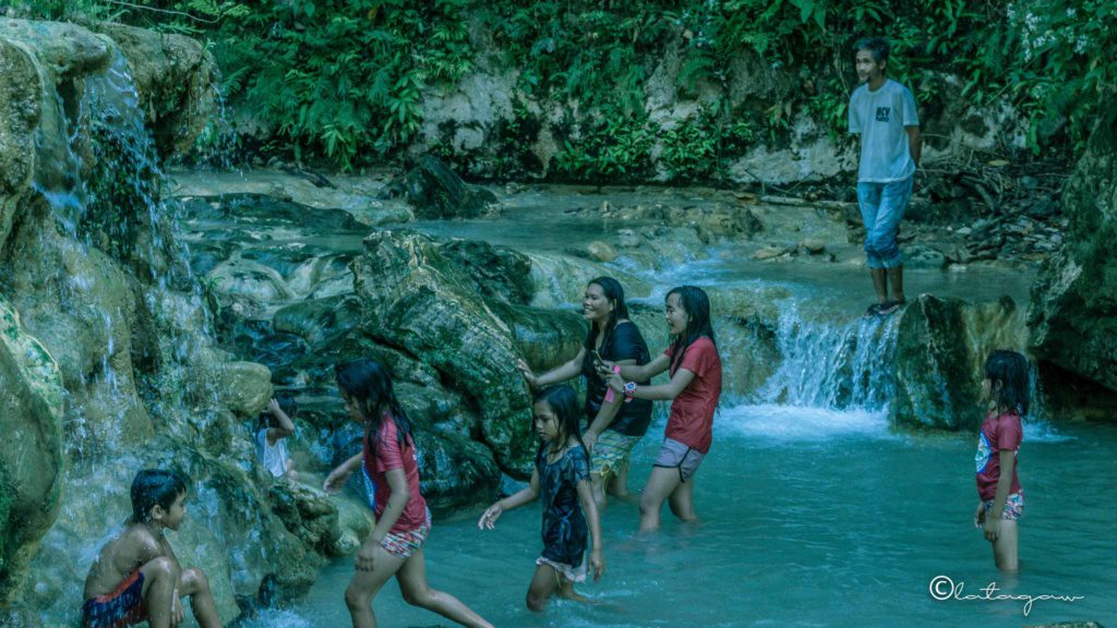 teenagers enjoying themselves at mainit sulfuric hot spring